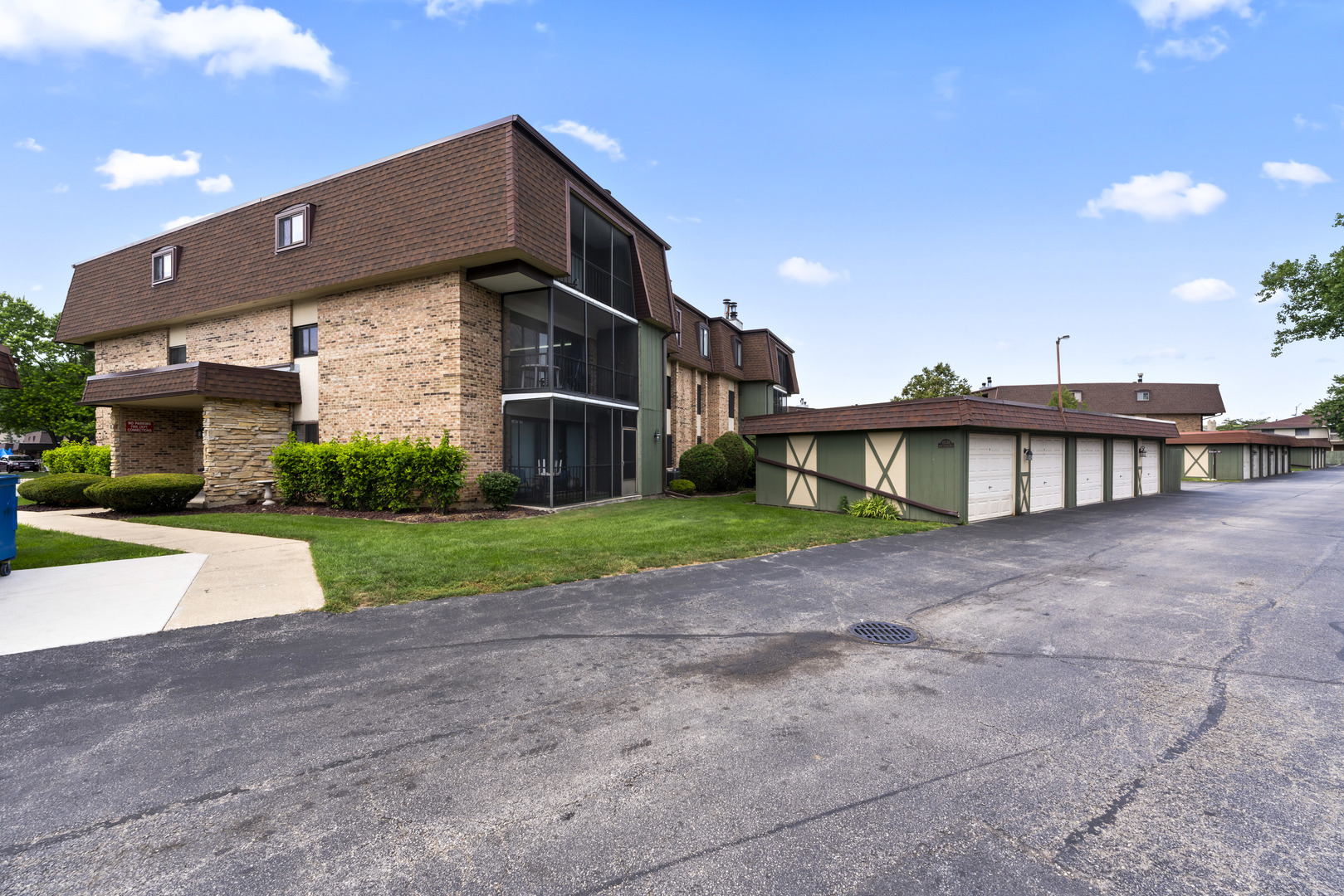 11138 Center Road, Unit D22 Palos Hills, IL 60465 - Photo 2 of 21 a front view of a house with a yard and garage