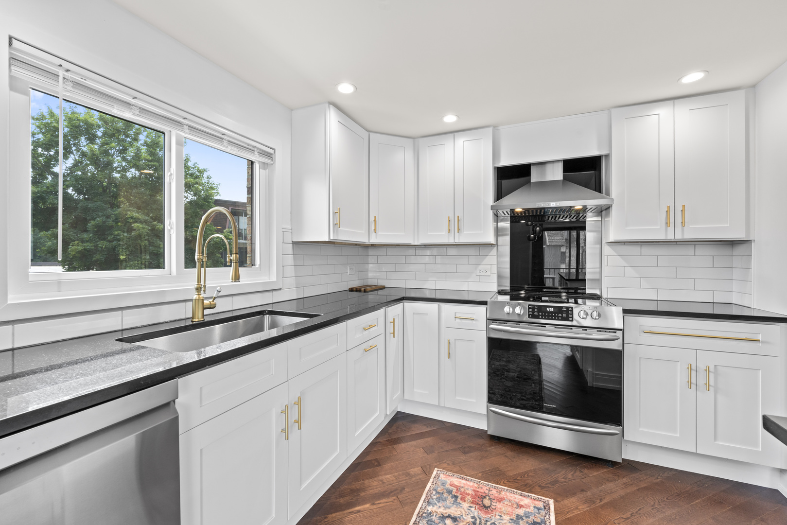 11138 Center Road, Unit D22 Palos Hills, IL 60465 - Photo 6 of 21 a kitchen with stainless steel appliances granite countertop a stove a sink and a microwave