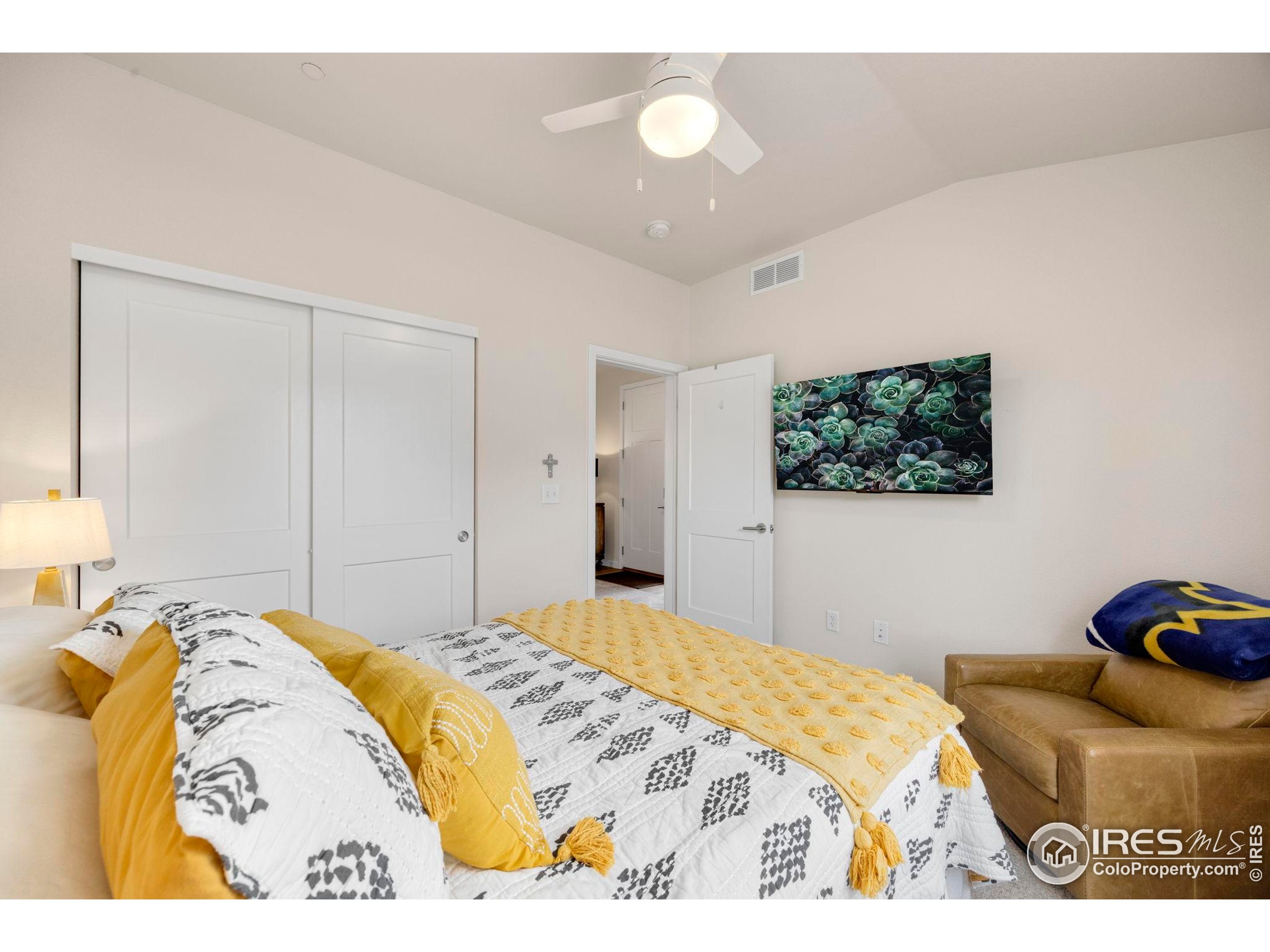 744 Wagon Trail Road, Unit 1 Fort Collins, CO 80524 - Photo 15 of 28 a bedroom with a bed and a couch