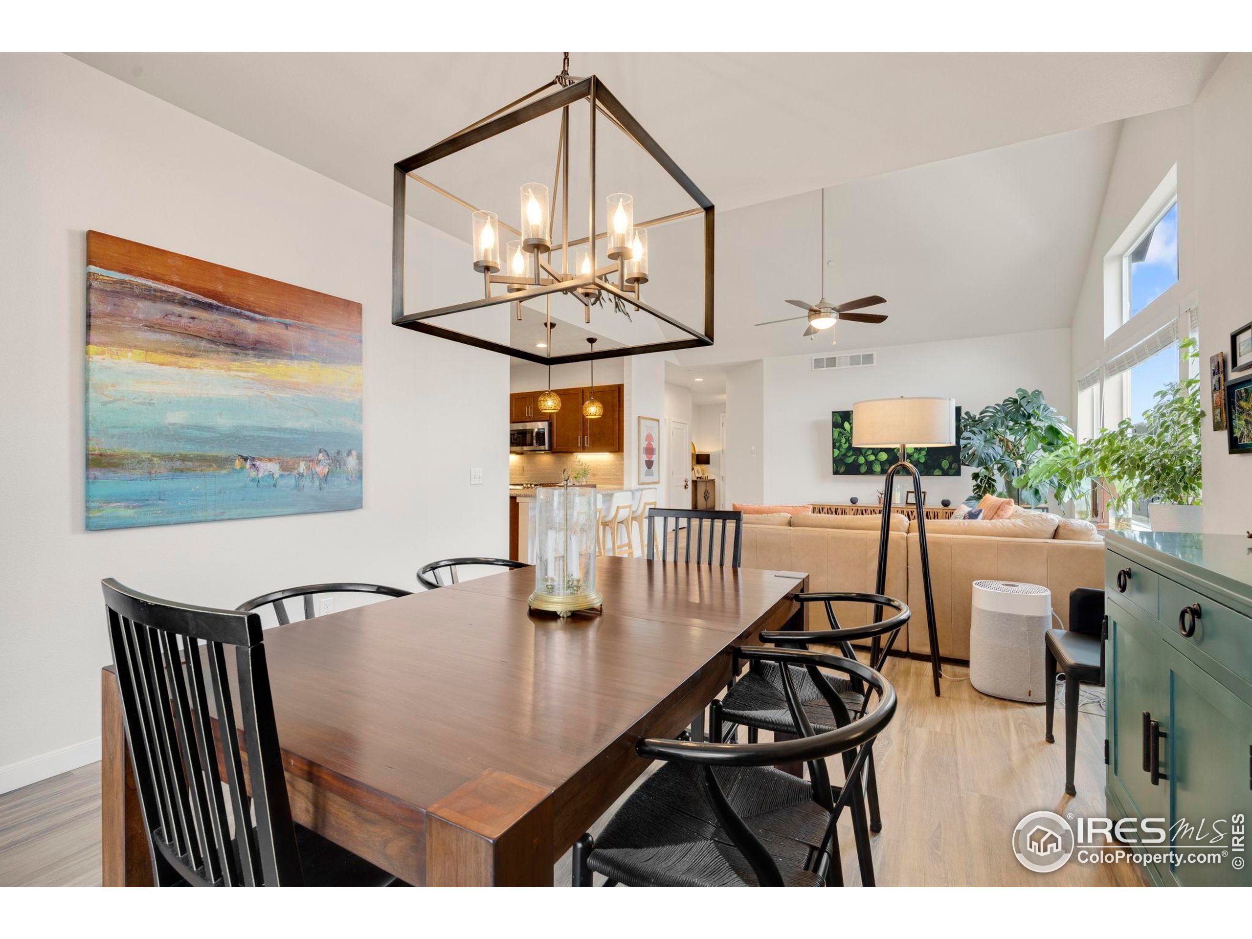 744 Wagon Trail Road, Unit 1 Fort Collins, CO 80524 - Photo 20 of 28 a view of a dining room with furniture a chandelier and wooden floor