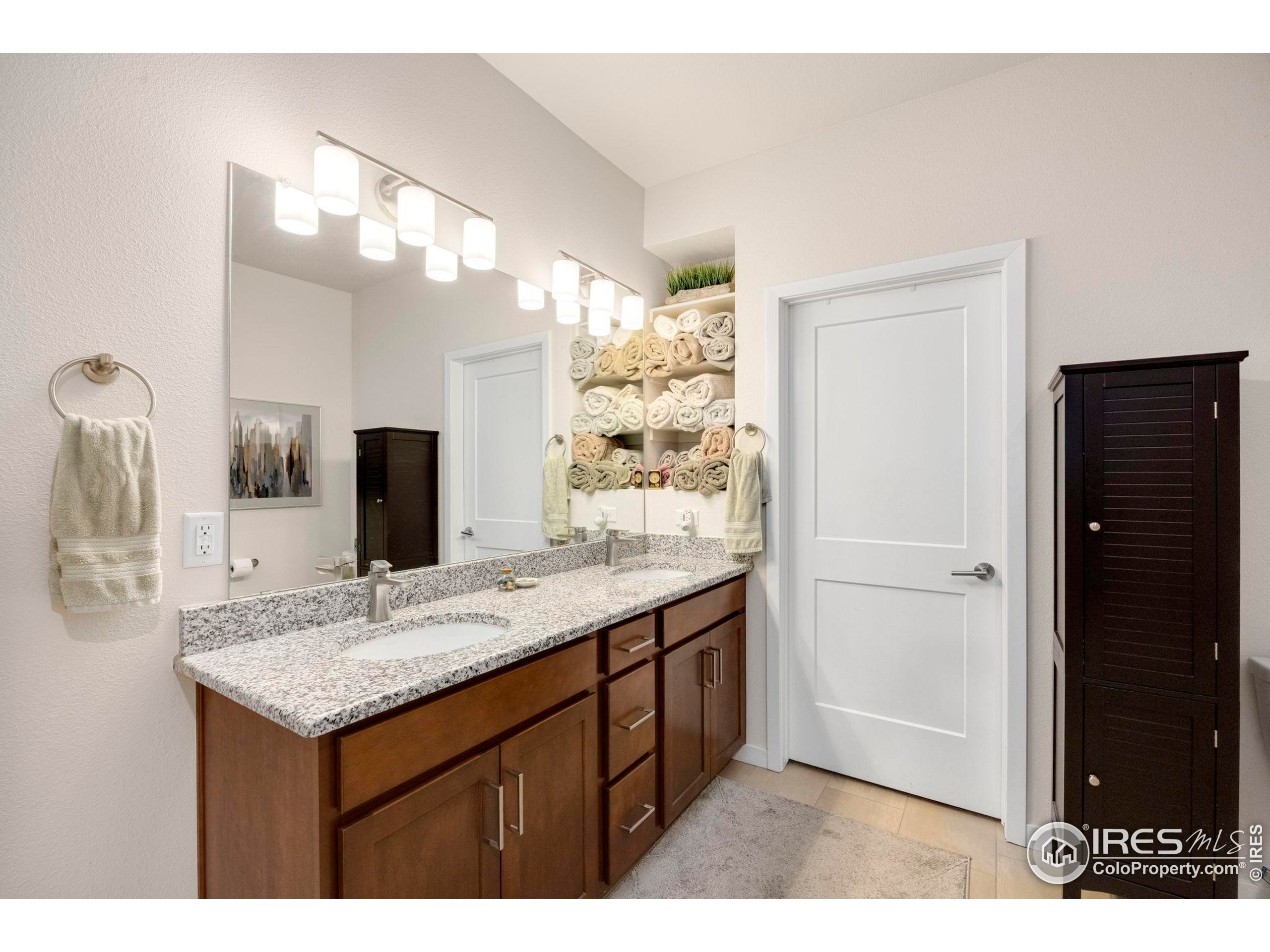 744 Wagon Trail Road, Unit 1 Fort Collins, CO 80524 - Photo 10 of 28 a bathroom with a sink and a mirror