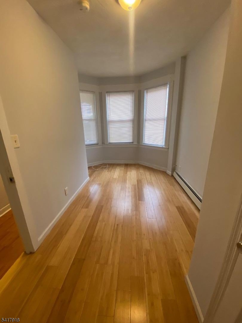 a view of hallway with wooden floor