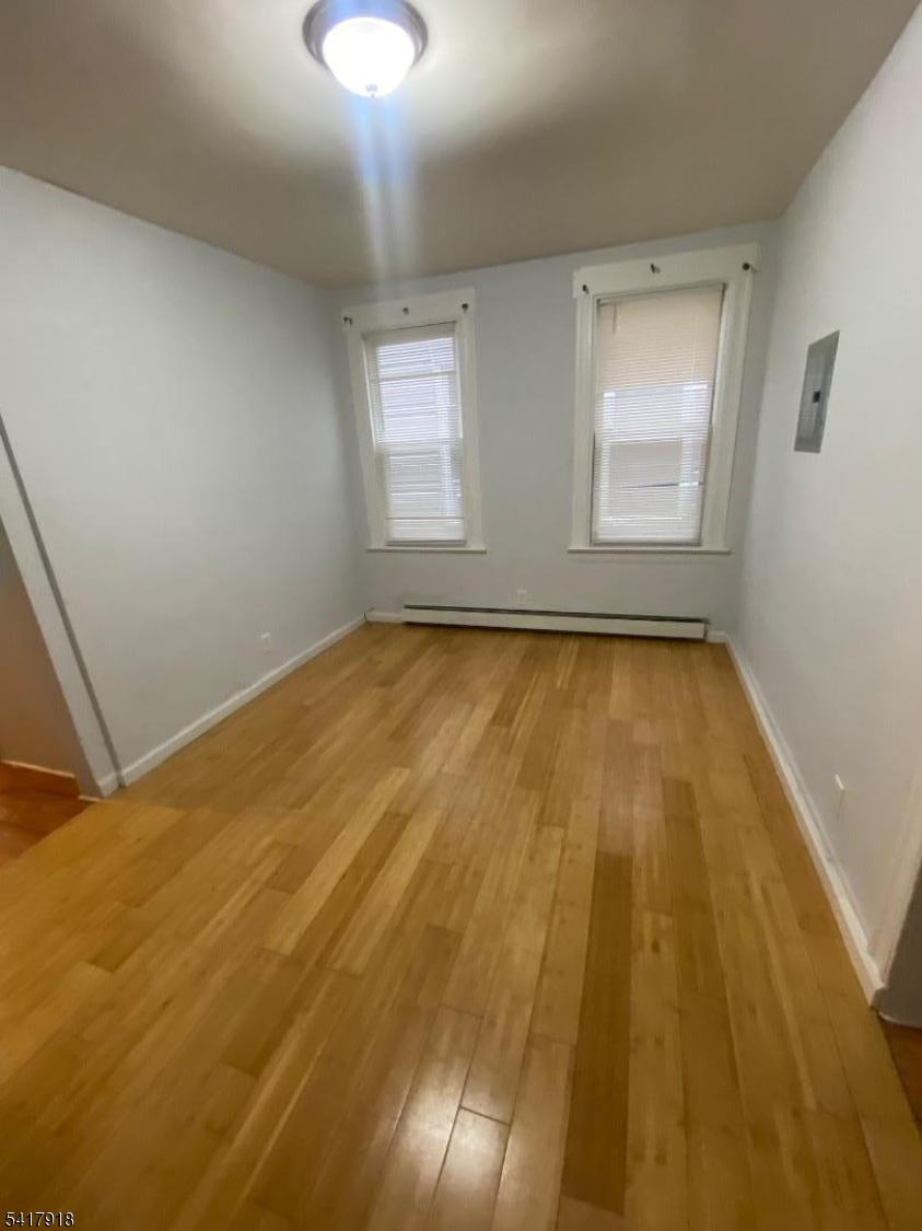 27 Pingry Place, Unit 1 Elizabeth, NJ 07208 - Photo 2 of 10 a view of a room with wooden floor and windows
