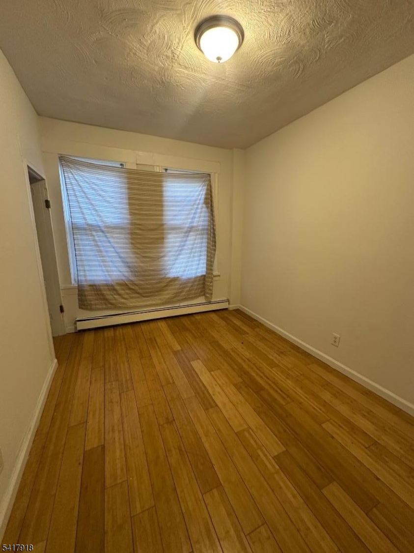 27 Pingry Place, Unit 1 Elizabeth, NJ 07208 - Photo 9 of 10 a view of a room with wooden floor