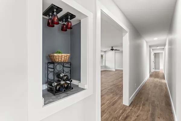 a view of a hallway with wooden floor and a workspace
