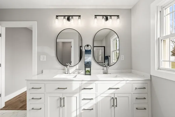 a bathroom with mirror a sink and a mirror