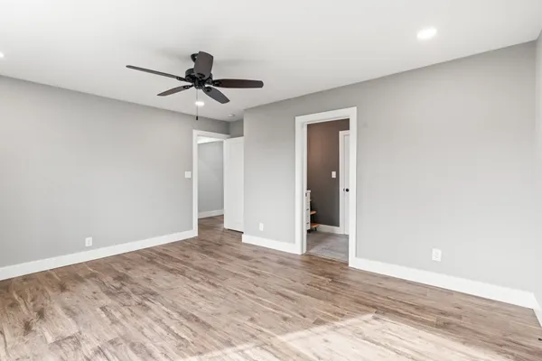 a view of an empty room with a ceiling fan