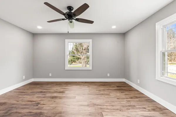 wooden floor in an empty room with a window