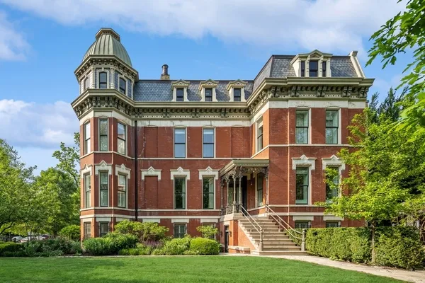 an aerial view of a house with a yard