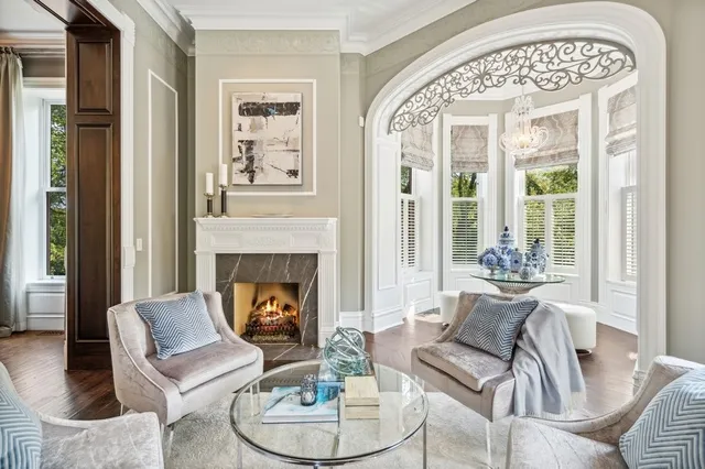 a kitchen with white cabinets and wooden floors