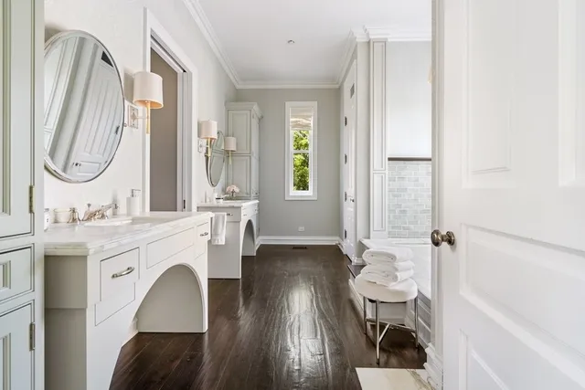 a kitchen with stainless steel appliances granite countertop a refrigerator a sink and white cabinets