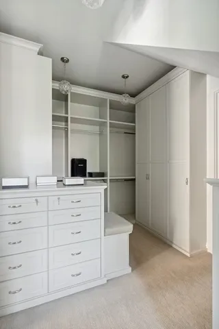 a view of a hallway with wooden floor and furniture