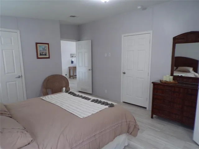a bedroom with a bed and a dresser
