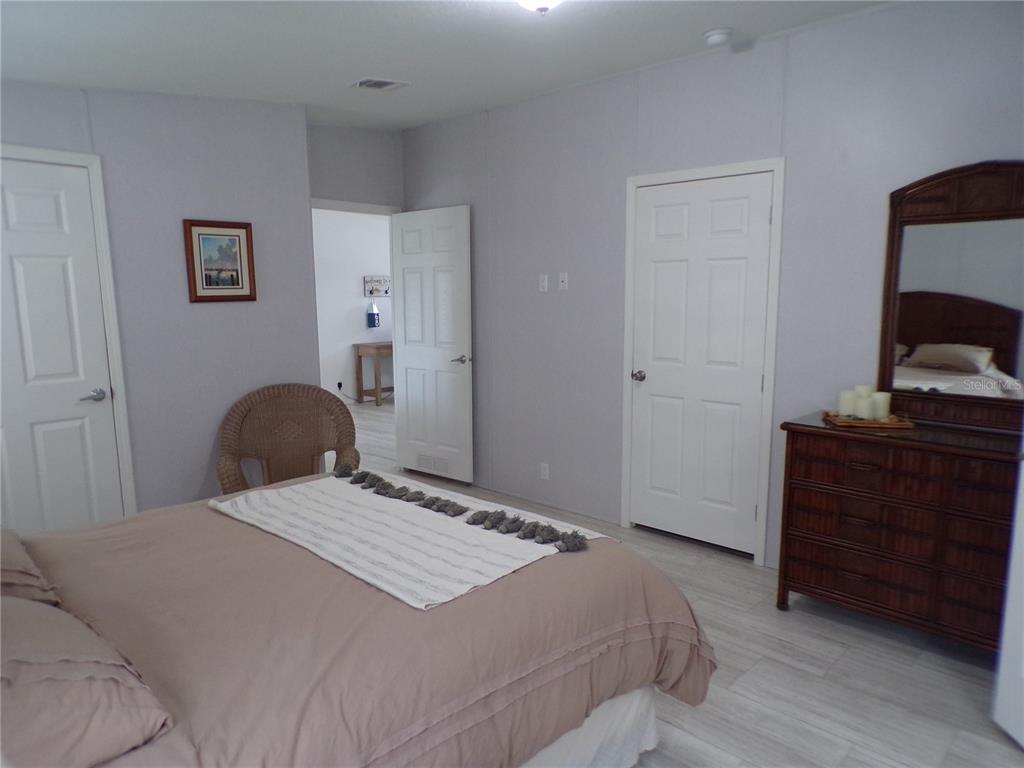 721 Marlin Drive Punta Gorda, FL 33950 - Photo 16 of 50 a bedroom with a bed and a dresser