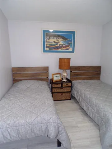 a bedroom with a bed and a painting on the wall