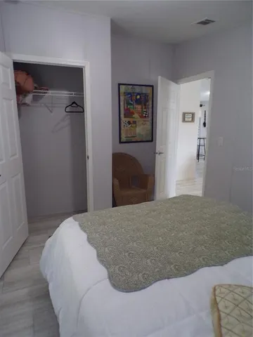 a bedroom with a bed and cabinets