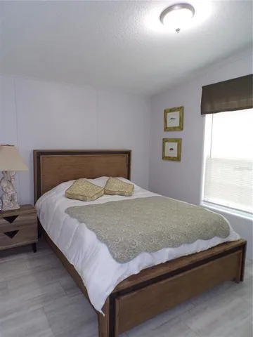 a bedroom with a bed and window