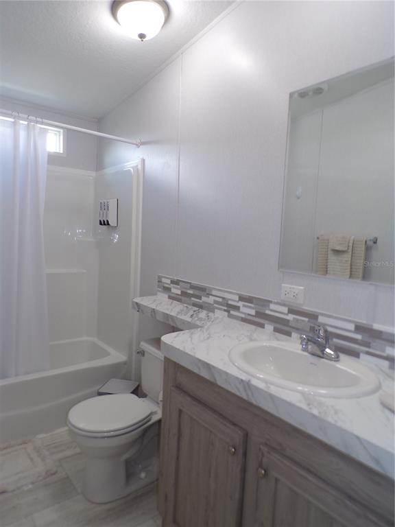 721 Marlin Drive Punta Gorda, FL 33950 - Photo 24 of 50 a bathroom with a granite countertop toilet a sink and shower