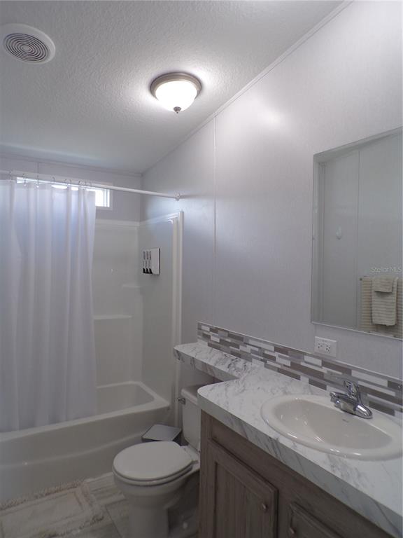721 Marlin Drive Punta Gorda, FL 33950 - Photo 26 of 50 a bathroom with a granite countertop sink toilet and shower