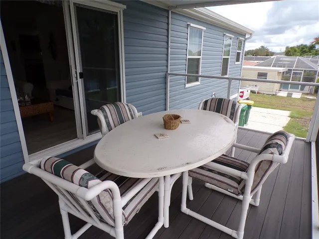 a balcony with table and chairs
