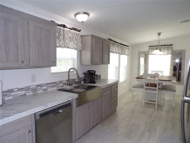 a kitchen with a sink stove and cabinets
