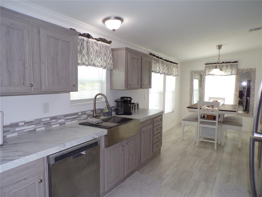 721 Marlin Drive Punta Gorda, FL 33950 - Photo 3 of 50 a kitchen with a sink stove and cabinets