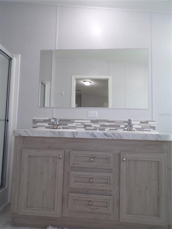 721 Marlin Drive Punta Gorda, FL 33950 - Photo 49 of 50 a bathroom with a granite countertop sink and a mirror