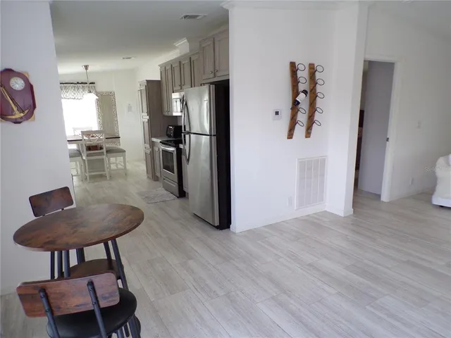 a kitchen with stainless steel appliances kitchen island a refrigerator and a stove