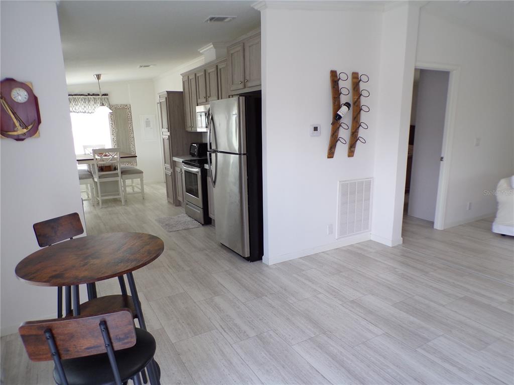 721 Marlin Drive Punta Gorda, FL 33950 - Photo 6 of 50 a kitchen with stainless steel appliances kitchen island a refrigerator and a stove