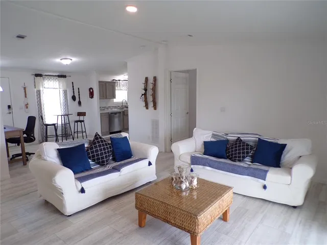 a living room with furniture a rug and a table