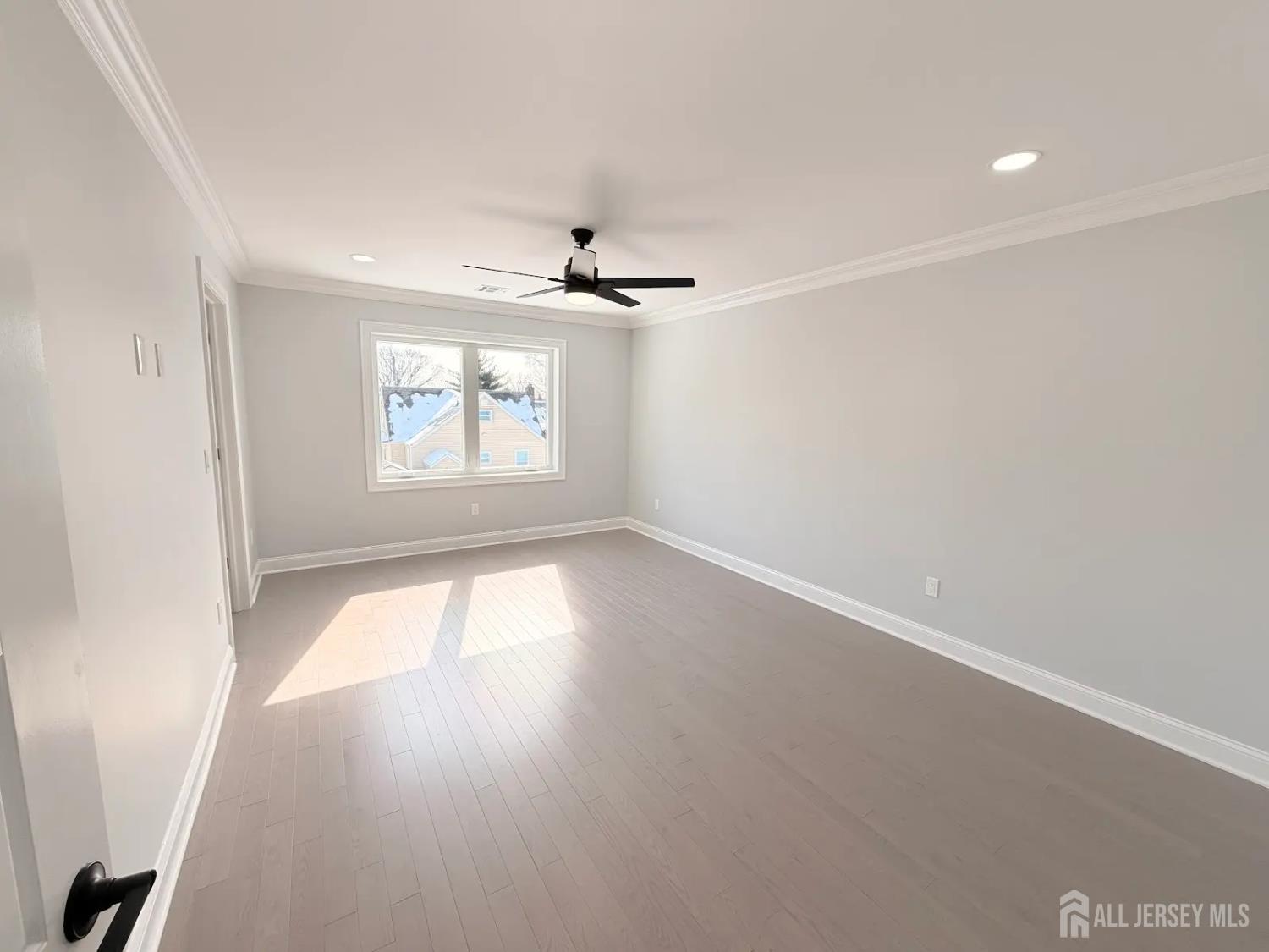 40 Foyer Street Edison, NJ 08817 - Photo 7 of 12 an empty room with windows and ceiling fan