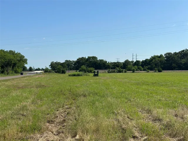 a view of a green field with clear sky