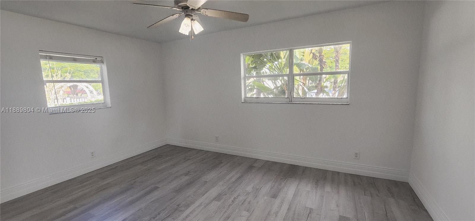 200 Northwest 9th Street Boca Raton, FL 33432 - Photo 22 of 61 an empty room with a window and wooden floor