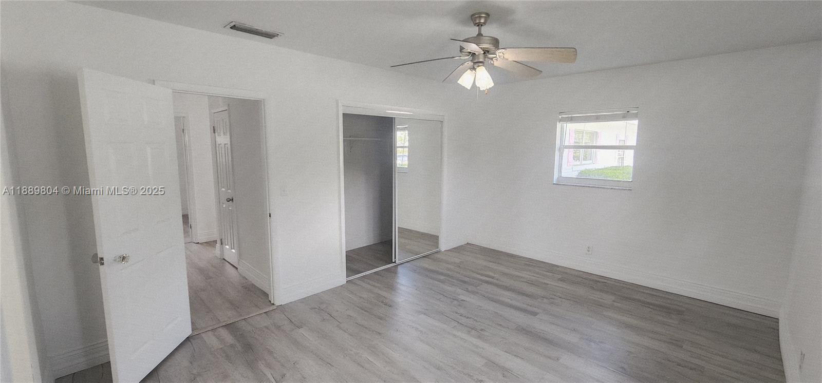 200 Northwest 9th Street Boca Raton, FL 33432 - Photo 25 of 61 wooden floor in an empty room with a window