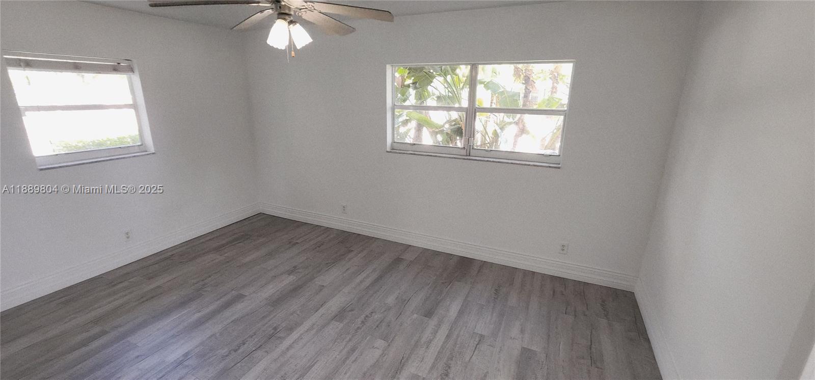 200 Northwest 9th Street Boca Raton, FL 33432 - Photo 28 of 61 an empty room with wooden floor and windows