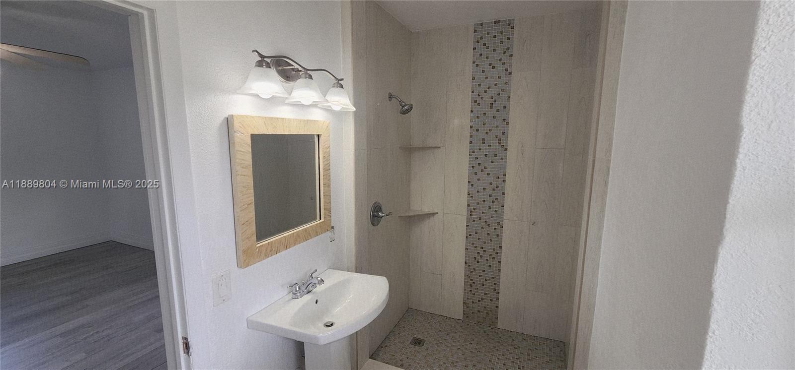 200 Northwest 9th Street Boca Raton, FL 33432 - Photo 30 of 61 a bathroom with a sink and mirror