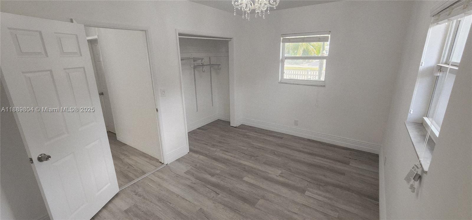 200 Northwest 9th Street Boca Raton, FL 33432 - Photo 35 of 61 an empty room with wooden floor and window