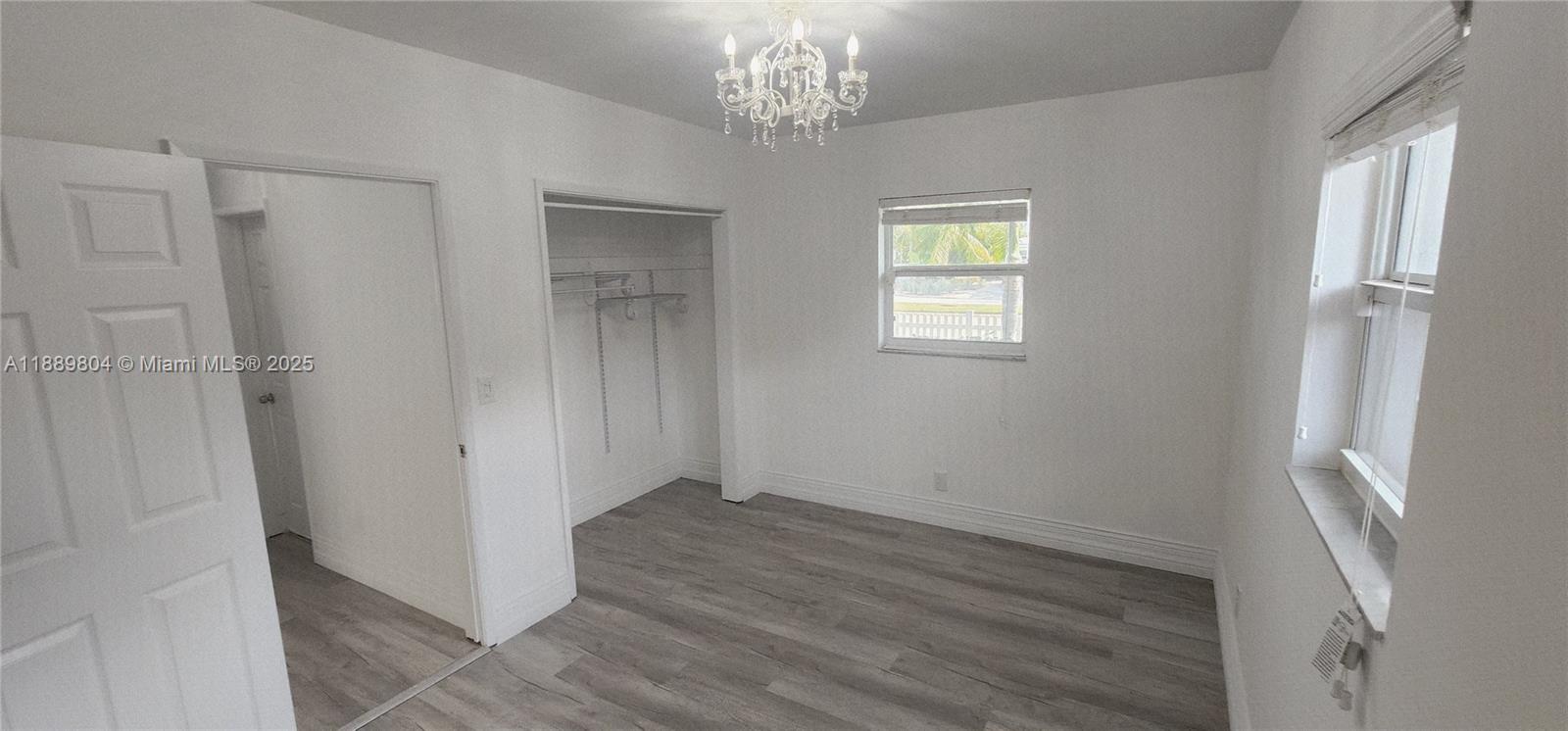 200 Northwest 9th Street Boca Raton, FL 33432 - Photo 37 of 61 a view of an empty room with wooden floor and a window