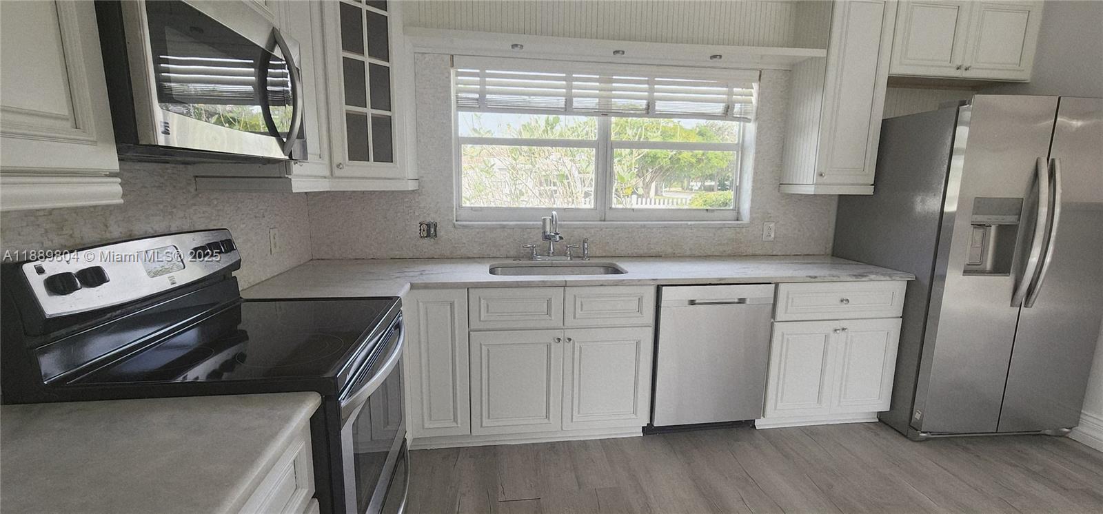 200 Northwest 9th Street Boca Raton, FL 33432 - Photo 4 of 61 a kitchen with a stove a sink and a refrigerator