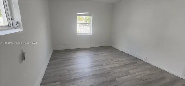 a view of a house with backyard and a tree