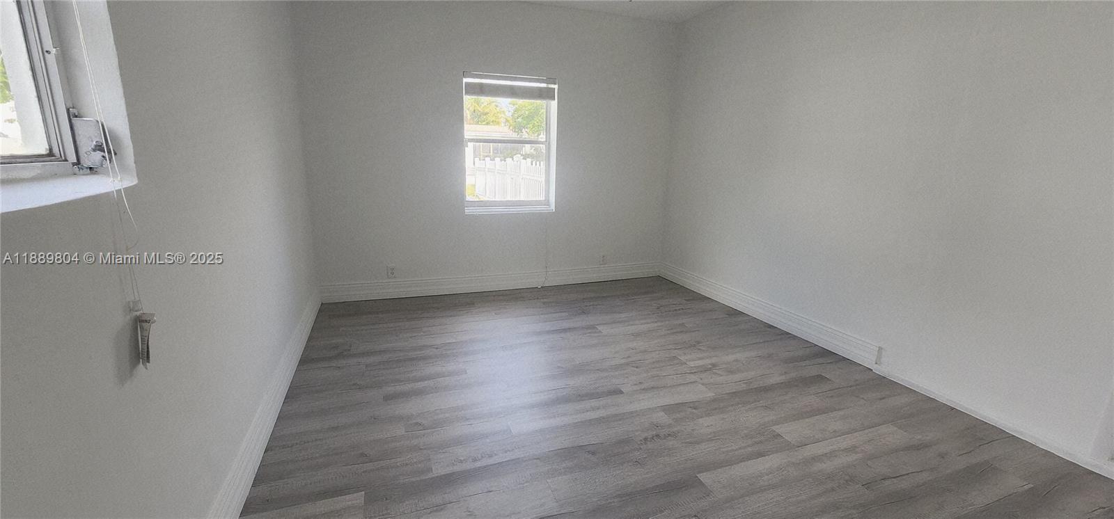 200 Northwest 9th Street Boca Raton, FL 33432 - Photo 44 of 61 an empty room with wooden floor and windows