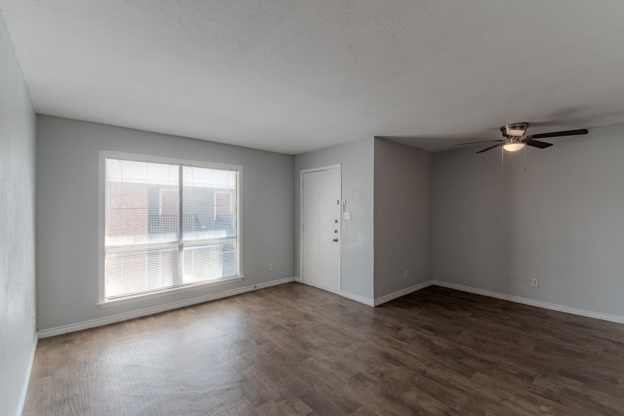 100 Uhland Road, Unit 3 San Marcos, TX 78666 - Photo 5 of 26 an empty room with wooden floor and windows