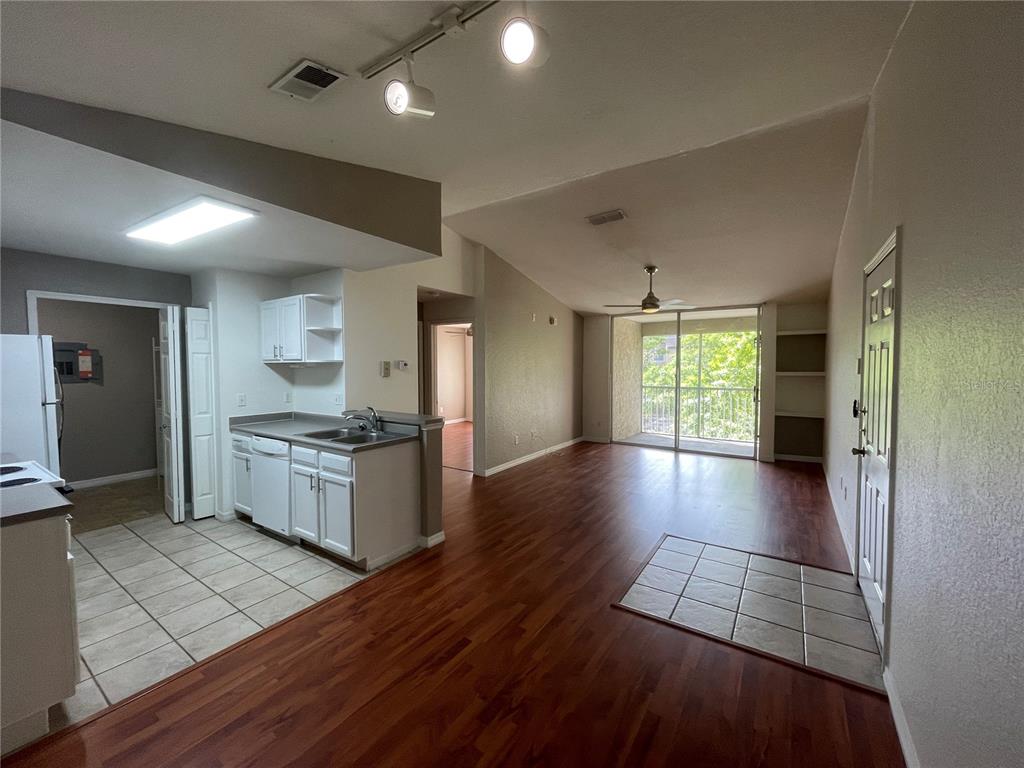 8915 Latrec Avenue, Unit 2307 Orlando, FL 32819 - Photo 2 of 5 a view of a kitchen with a sink and a stove top oven