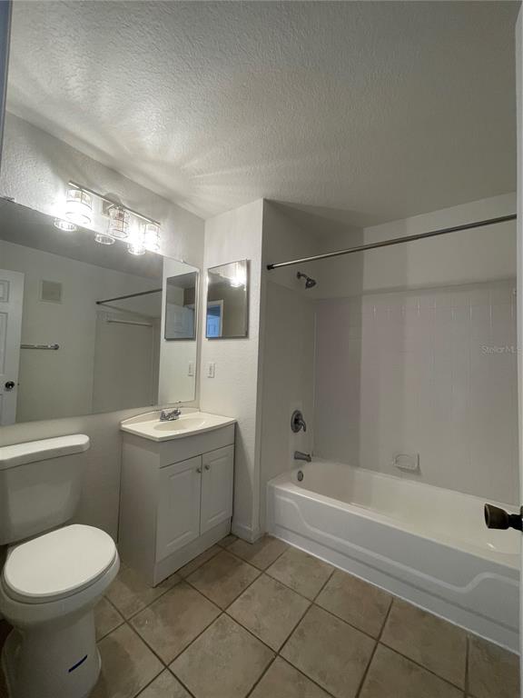 8915 Latrec Avenue, Unit 2307 Orlando, FL 32819 - Photo 4 of 5 a bathroom with a sink toilet and shower