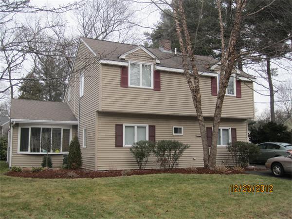 21 Longfellow Road Natick, MA 01760 - Photo 1 of 28 a front view of a house with a yard and garage