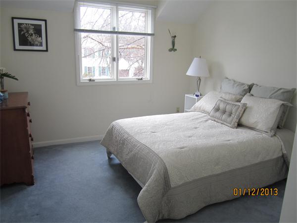 21 Longfellow Road Natick, MA 01760 - Photo 15 of 28 a bedroom with a bed and a lamp next to a window