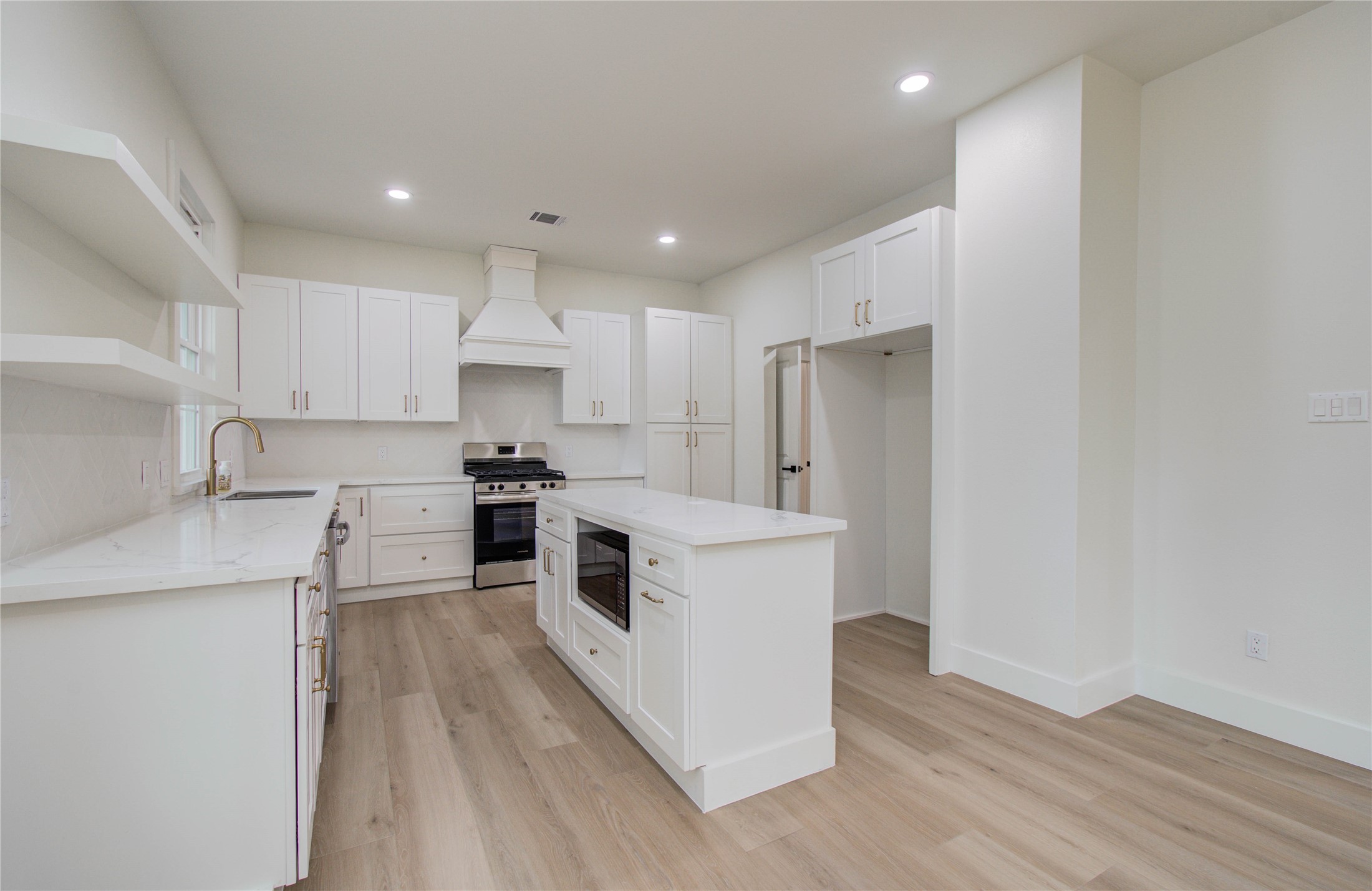 727 Travis Street Columbus, TX 78934 - Photo 12 of 36 a kitchen with stainless steel appliances granite countertop a stove a sink and a refrigerator