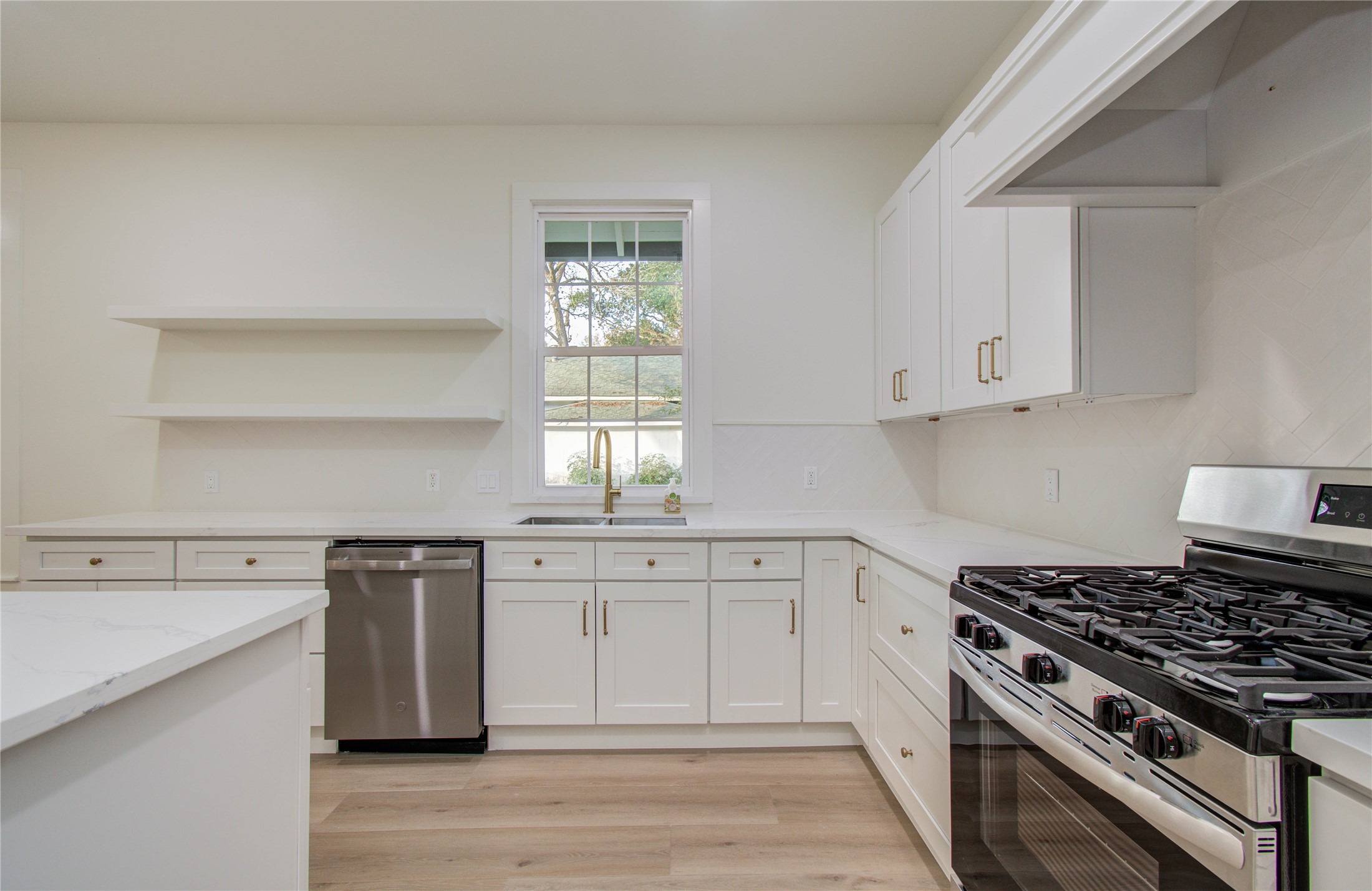 727 Travis Street Columbus, TX 78934 - Photo 15 of 36 a kitchen with cabinets appliances and a window