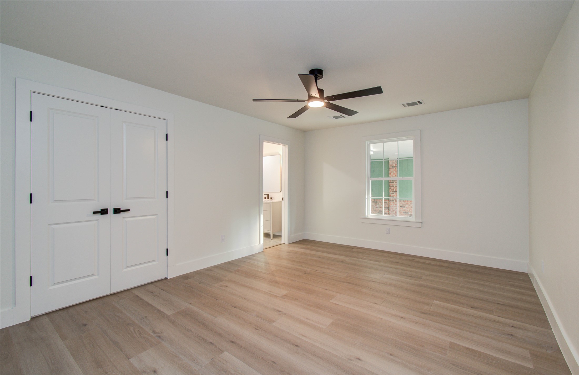 727 Travis Street Columbus, TX 78934 - Photo 20 of 36 Another secondary bedroom off of the kitchen. This bedroom was originally the primary & is so spacious! Also has an ensuite bathroom