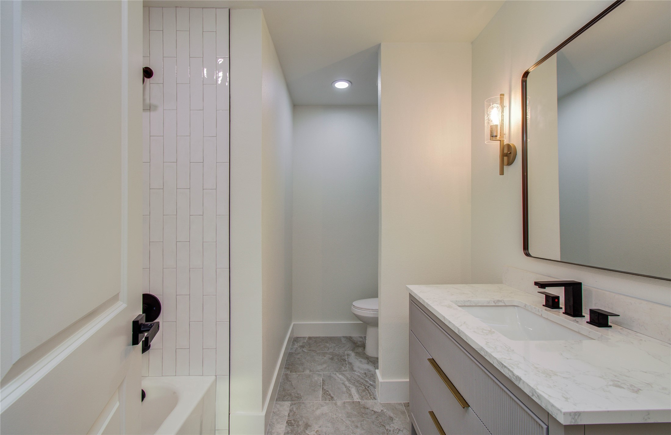 727 Travis Street Columbus, TX 78934 - Photo 22 of 36 a bathroom with a granite countertop sink a toilet and shower